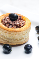puff pastry filled with terrine served with black olives