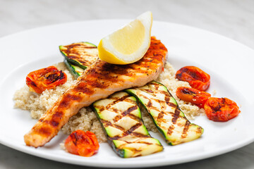 grilled poultry meat with tomatoes zucchini served with couscous