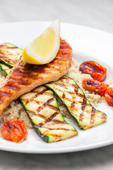 grilled poultry meat with tomatoes zucchini served with couscous