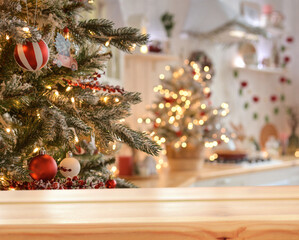 Empty wooden table on the background of christmas tree and blurred christmas kitchen, golden...