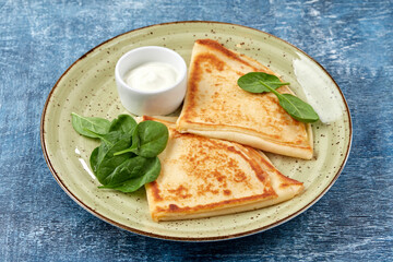 tasty breakfast with pancakes and herbs