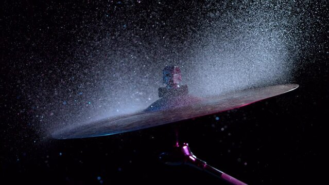 Super slow motion of drummer banging on cymbal with water splashing. Filmed on high speed cinema camera , 1000 fps.