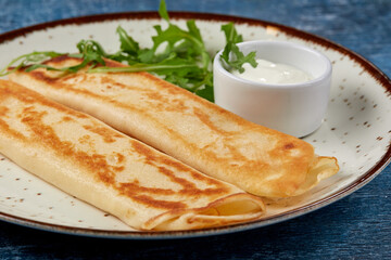 tasty breakfast with pancakes and herbs