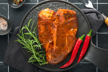 Raw steak t-bone or porterhouse. Steak t-bone or porterhouse in sauce with spices, salt and...