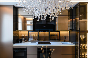 stylish and modern kitchen with illuminated mirror and black hood