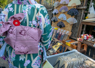 Unidentified Japanese lady wore green kimono shopping for good in Arashiyama, Japan.