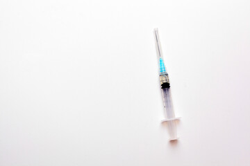 Medical syringe over white background with copyspace