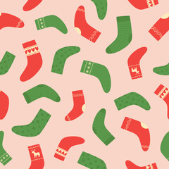 Seamless pattern of red and green Christmas socks on pink background. Doodle style. Christmas winter background. 