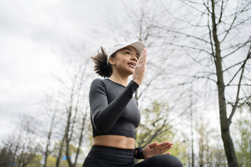 A female runner is running fitness training in a tight-fitting tracksuit.