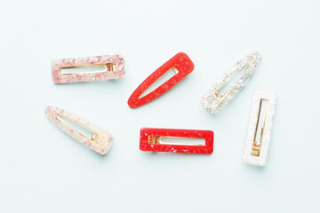 Fashionable, stylish colored hair clips on a colored background