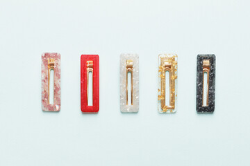Fashionable, stylish colored hair clips on a colored background