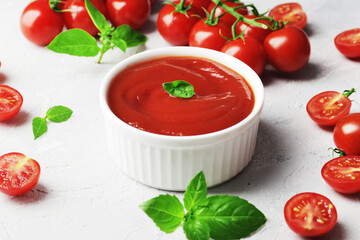 Tomato sauce in a bowl, Fresh basil and fresh cherry tomatoes. Ingredients for the sauce. Ingredients for cooking.