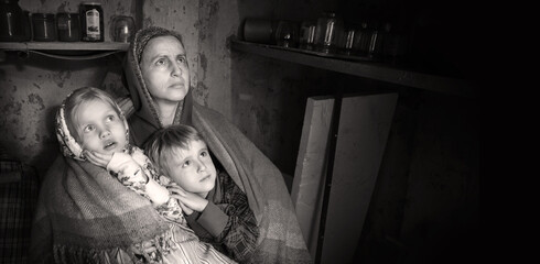 Frightened children with their mother hide in the cellar from the bombings. Kyiv. Ukraine. 8 May 2022