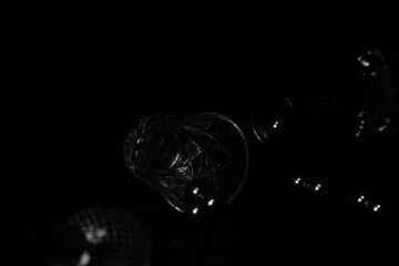 Glass and bottle on a black background