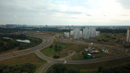 Dormitory area of a big city. Construction site of the church. Urban landscape. Aerial photography.
