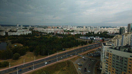 Obraz premium City with high-rise buildings. Park area in the foreground. Blue sky with clouds. Aerial photography.