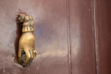 vintage hand doorknocker on entrace