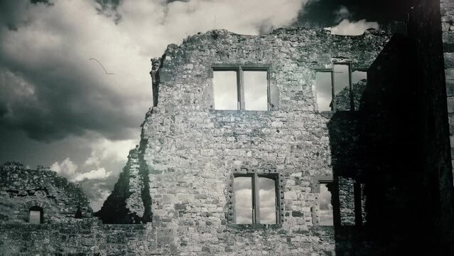 Old Derelict Building Ruin Vintage Style Film Texture, Zoom In. Ruins of an old building standing under a cloudy blue sky, zoom in. Old film texture