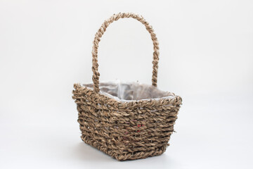 Fototapeta na wymiar empty wicker basket made of vines on a white background. Easter Item