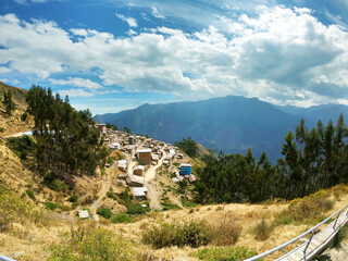 Ghost town among the immense Andean mountains under the blue Peruvian sky.