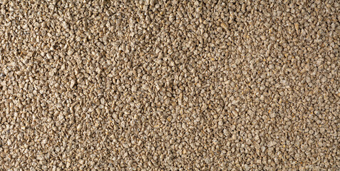 close-up of chicken feed crumble, semi-loose variety made from pellets cracked into smaller pieces, full frame background