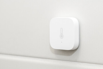 Fototapeta premium Smart heat sensor on the white wall.