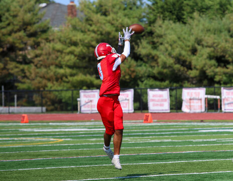 Football wide receiver catching a pass during a game