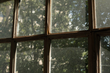 Old window frame. Glass on window. Interior details. Morning light on dusty glass.