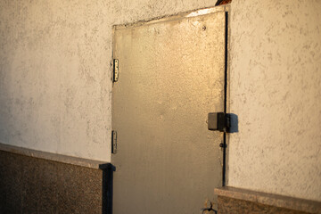Steel door in wall. Doorway. Details of technical building. Emergency entrance.
