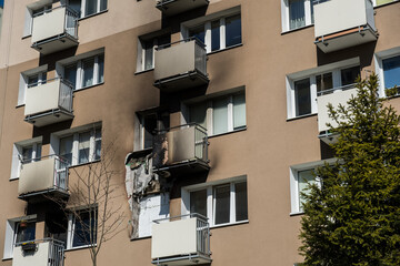 Fototapeta na wymiar Apartment windows burned after the fire in building from the 70s in Gdynia, Poland