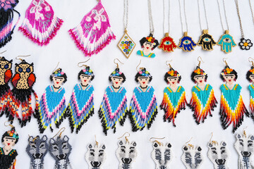Colorful huichol earrings at Chapala market in Guadalajara, Mexico. Traditional Mexican handmade souvenirs