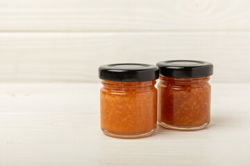 Nut honey jar on white wood. Cold medicine. Useful fortified product with almonds, pistachios, star anise and cinnamon for health and beauty. Vegetarian diet organic product. Copy space.place for text