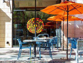 Empty cafe with tables and chairs. Street exterior of a restaurant in Cherry Creek district,...