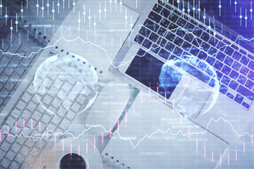 Financial market graph and top view computer on the desktop background. Multi exposure. Investment concept.