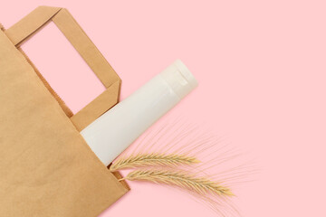 Craft package with cosmetic cream. Ears of wheat. Natural product.