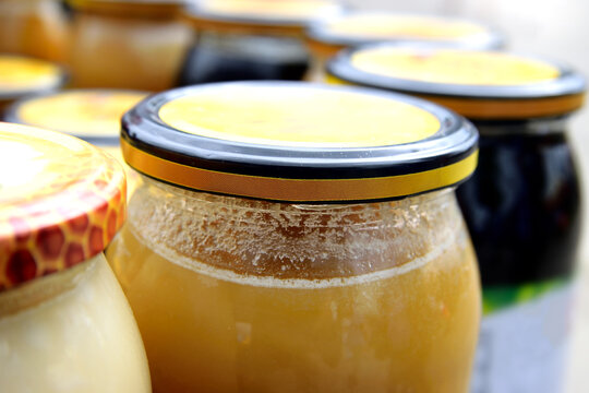 Close-up of Jars with various types of organic honey for sale in the local rural market.