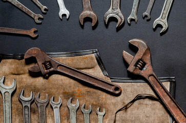 Vintage tool kit for repair and reconstruction at home lie on a black background