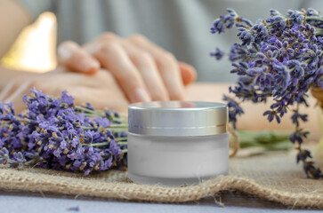 Obraz na płótnie Canvas Closed jar of lavender moisturizer. Jar of body cream and fresh lavender flowers