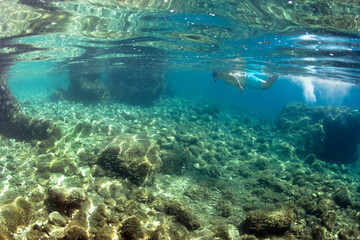 Fototapeta na wymiar Man snorkeling in the sea.