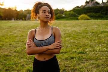 Young black sportswoman standing during yoga practice
