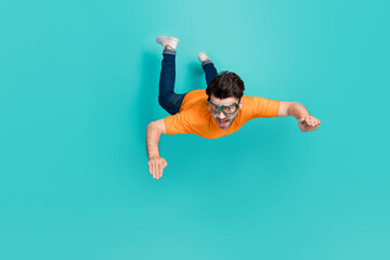 Full size photo of guy trying sky diving outdoors sport falling down isolated on cyan color...