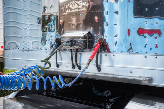 Red, White And Blue Connectors From The Tractor Cab To The Trailer Of This Semi.  Providing Power From The Tractor To The Trailer Of A Blue Truck In  Upstate NY.