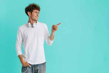 Young handsome smiling man with headphones on his neck