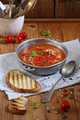 Gaspacho soup on wooden background with toasted bread