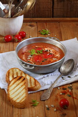 Gazpacho soup on wooden background with toasted bread