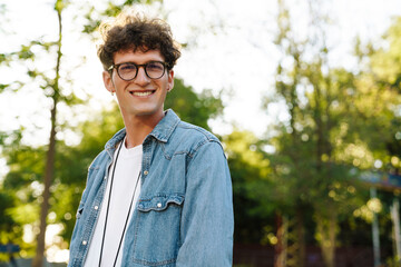 Portrait of young handsome smiling stylish boy in glasses