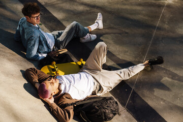 Two young handsome stylish boys lying on the floor