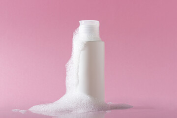 Cosmetics for face, body and hair care. Moisturizer, shampoo or facial cleanser on pink background...