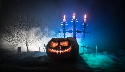 Scary view of zombies at cemetery at night. Dead tree and spooky cloudy sky with fog. Horror...