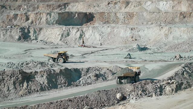 Production useful minerals. Mining dumper truck mining machinery transport ore from open-pit production site, slow motion